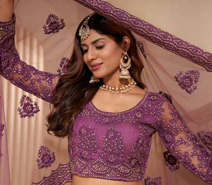Elegant dark orchid net lehenga with silk inner and thread &amp; cording embroidery.