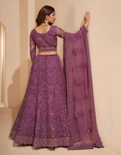 Elegant dark orchid net lehenga with silk inner and thread &amp; cording embroidery.