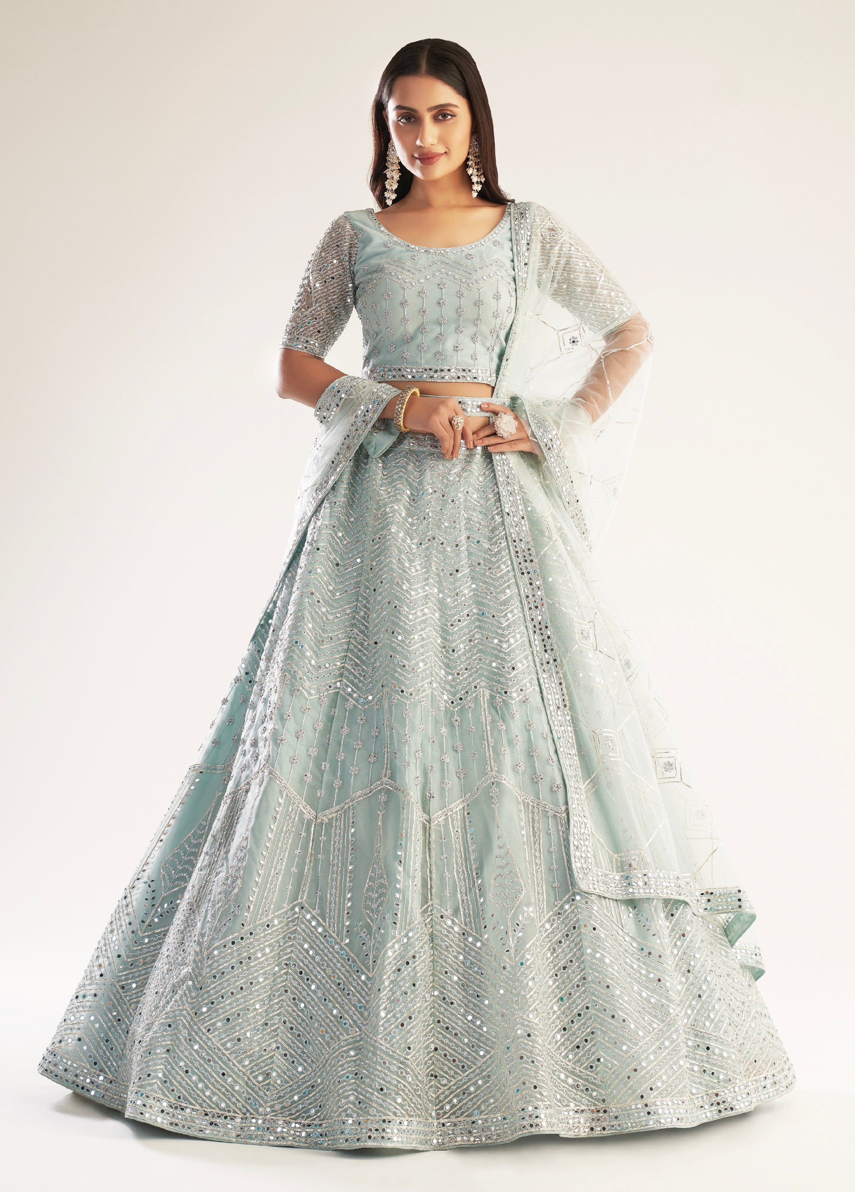 Elegant pastel ocean blue bridal lehenga with ribbon gota work and heavy zarkan embellishments.
