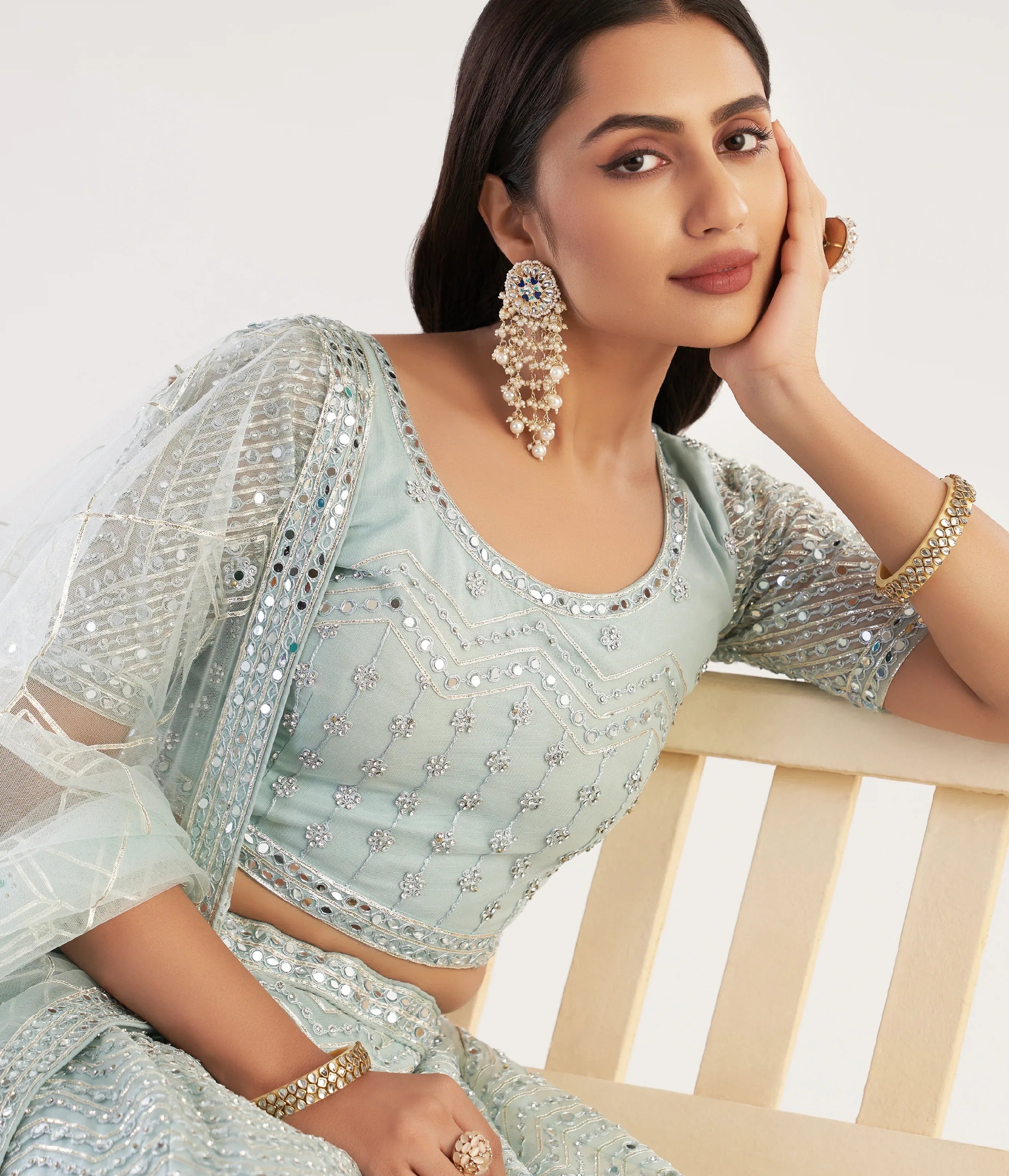 Elegant pastel ocean blue bridal lehenga with ribbon gota work and heavy zarkan embellishments.