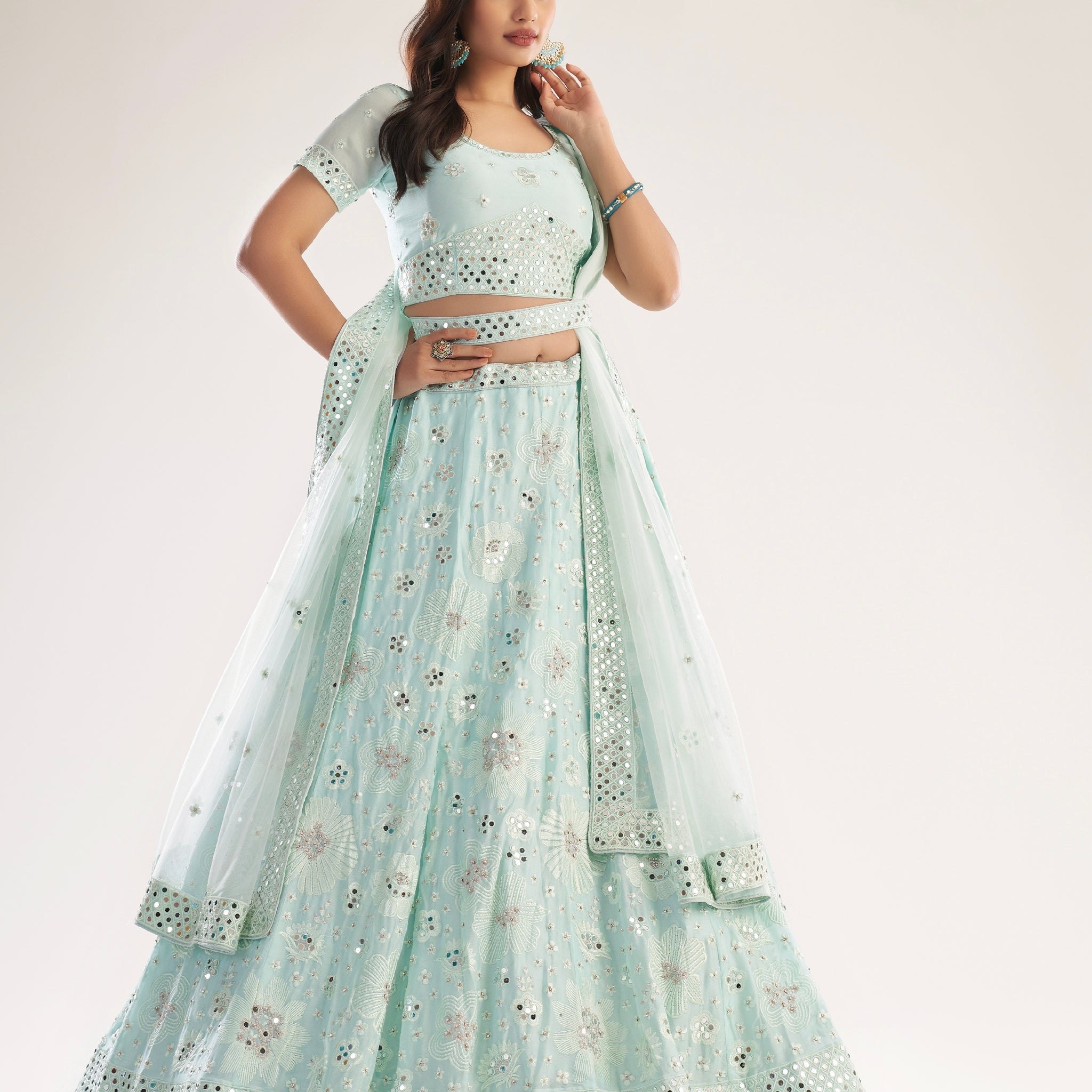 Elegant sea green bridal lehenga with heavy thread, zari embroidery, zarkan, and mirror work.