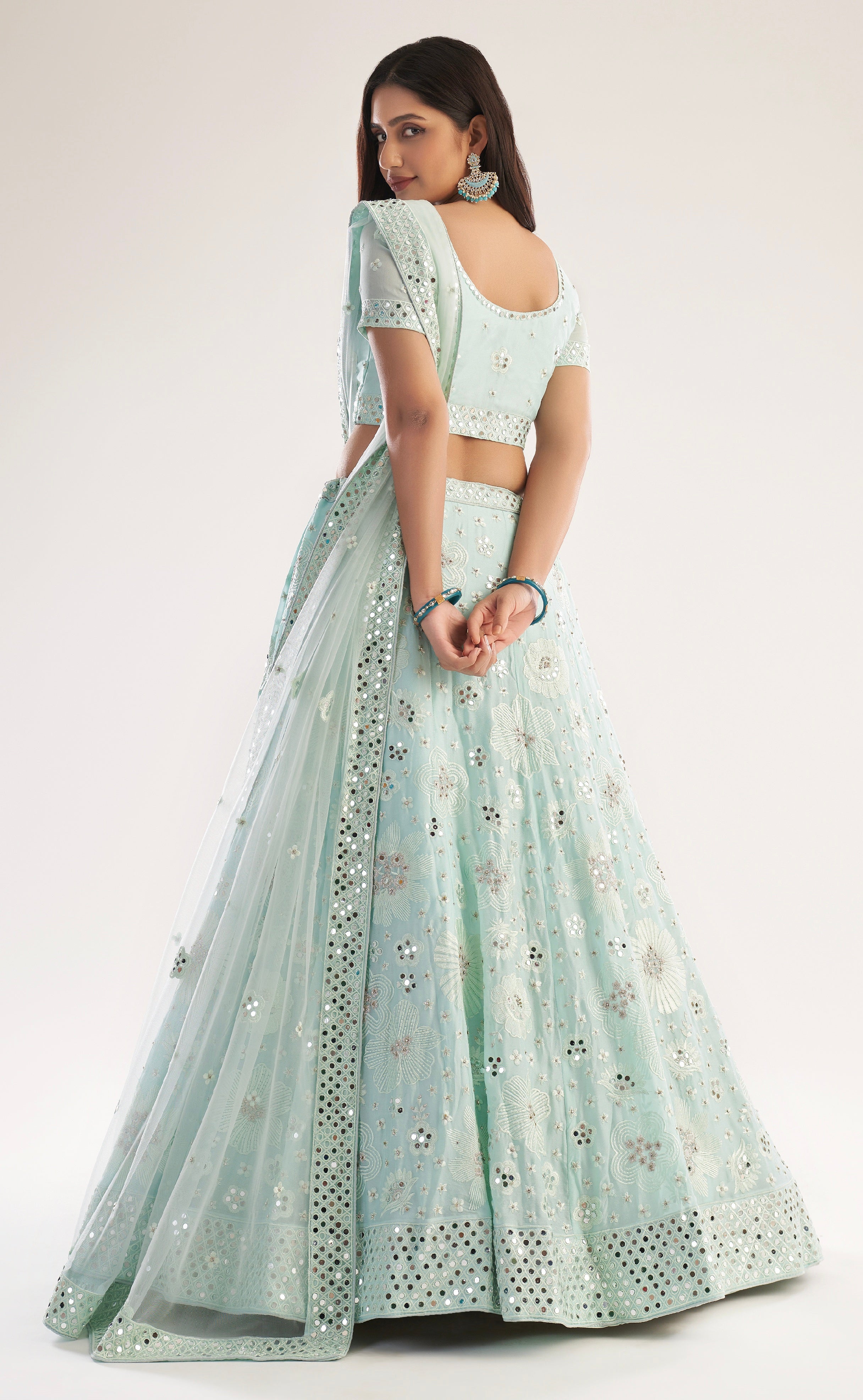 Elegant sea green bridal lehenga with heavy thread, zari embroidery, zarkan, and mirror work.