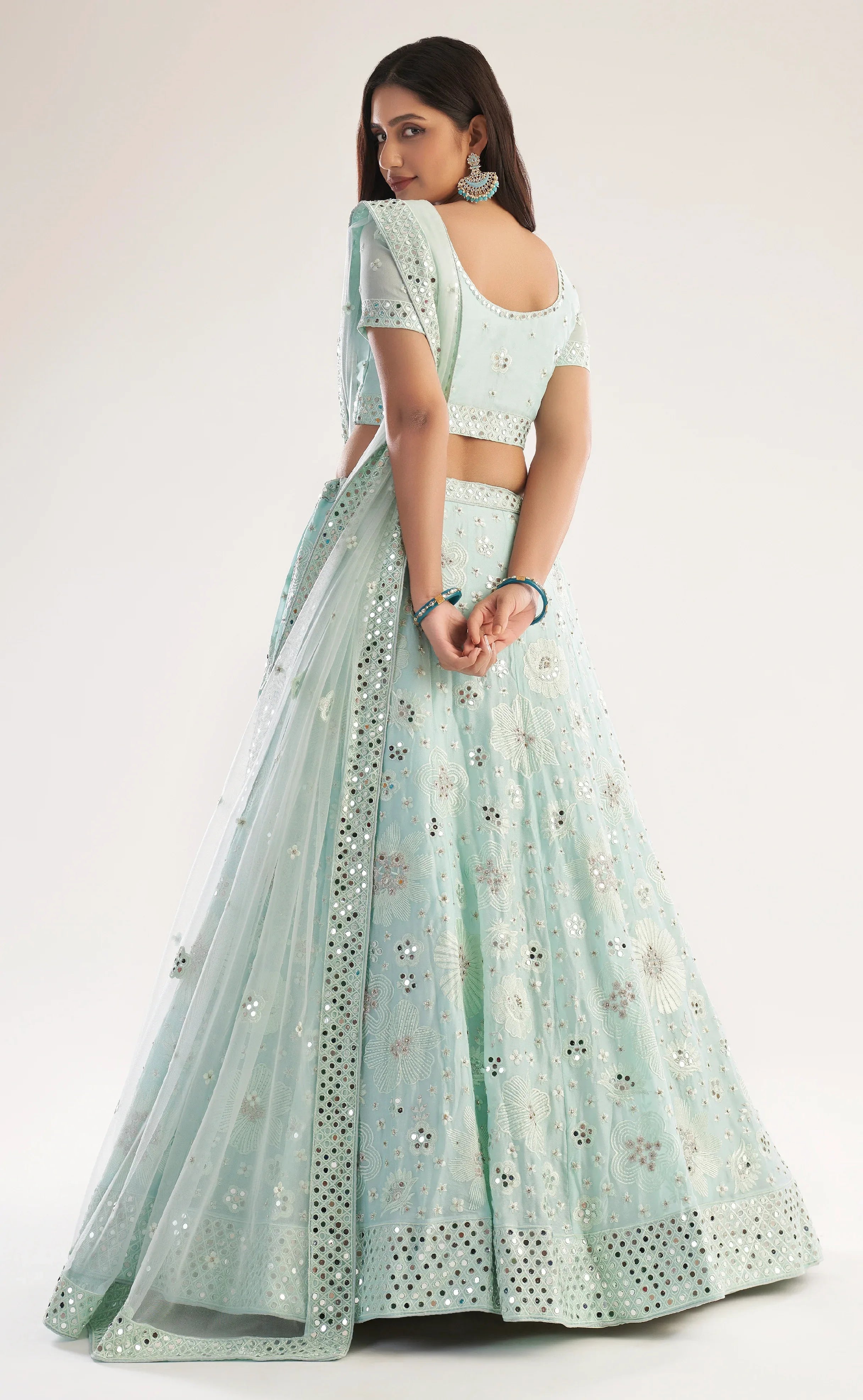 Elegant sea green bridal lehenga with heavy thread, zari embroidery, zarkan, and mirror work.