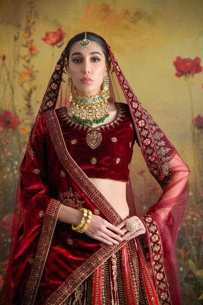 Heavy hand-embroidered bridal lehenga in maroon velvet with rich gold detailing