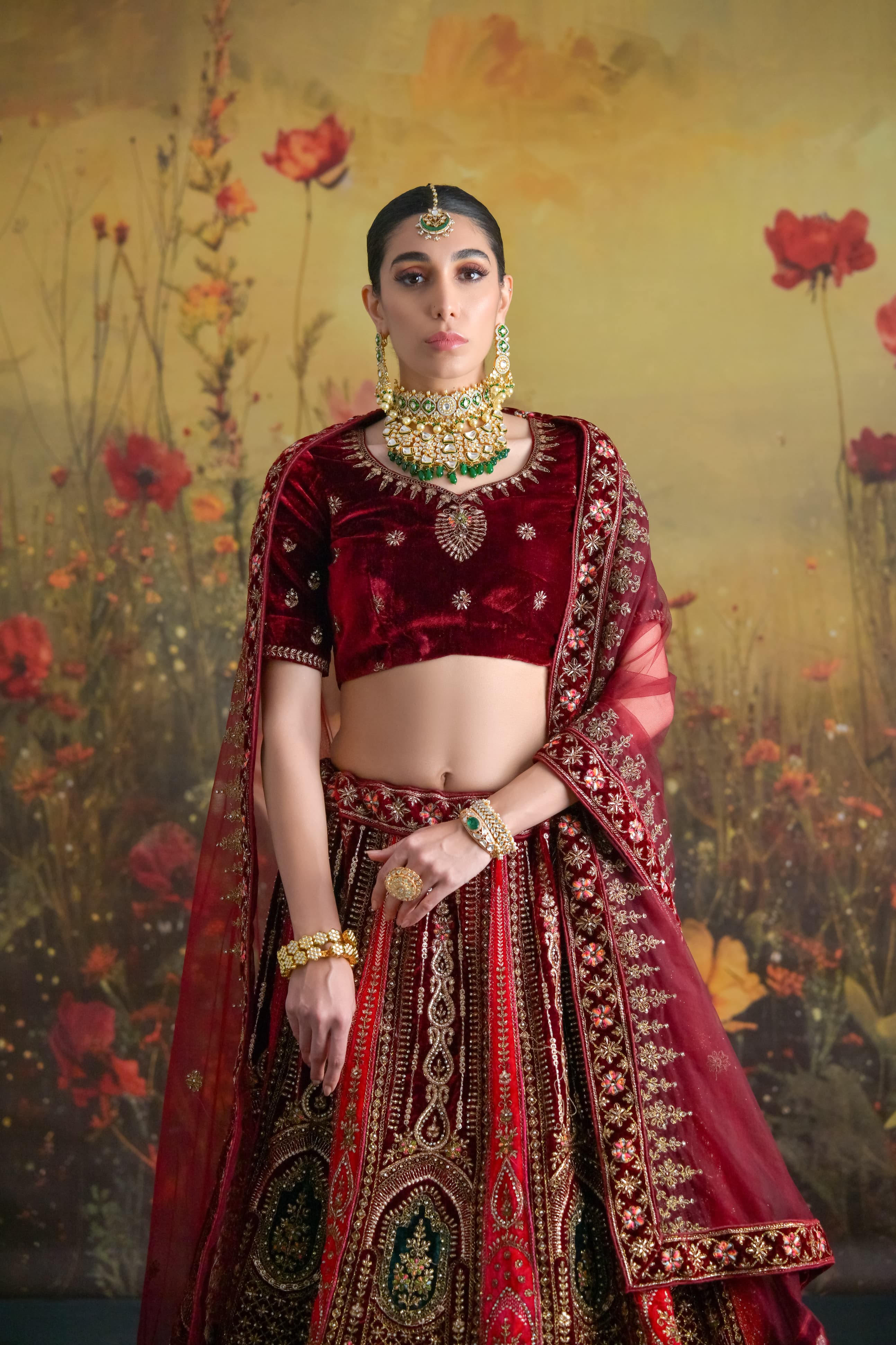Maroon bridal lehenga crafted in plush velvet with golden thread work