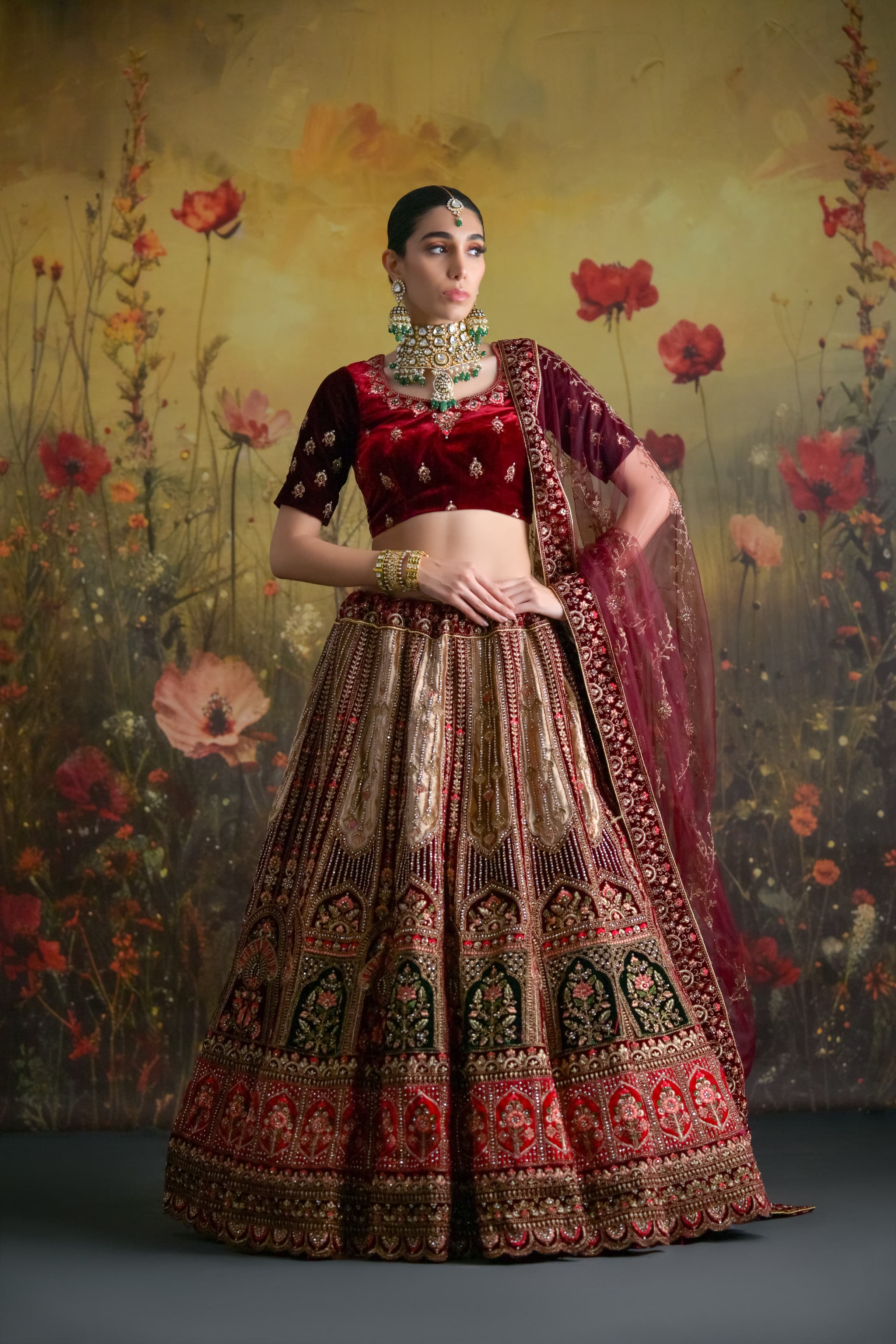 Heavy zardosi bridal lehenga in deep wine velvet with rich gold embellishments and royal finish
