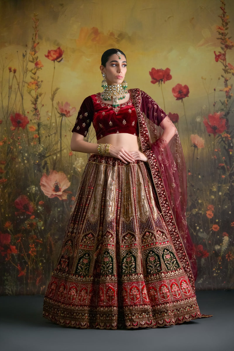 Heavy zardosi bridal lehenga in deep wine velvet with rich gold embellishments and royal finish