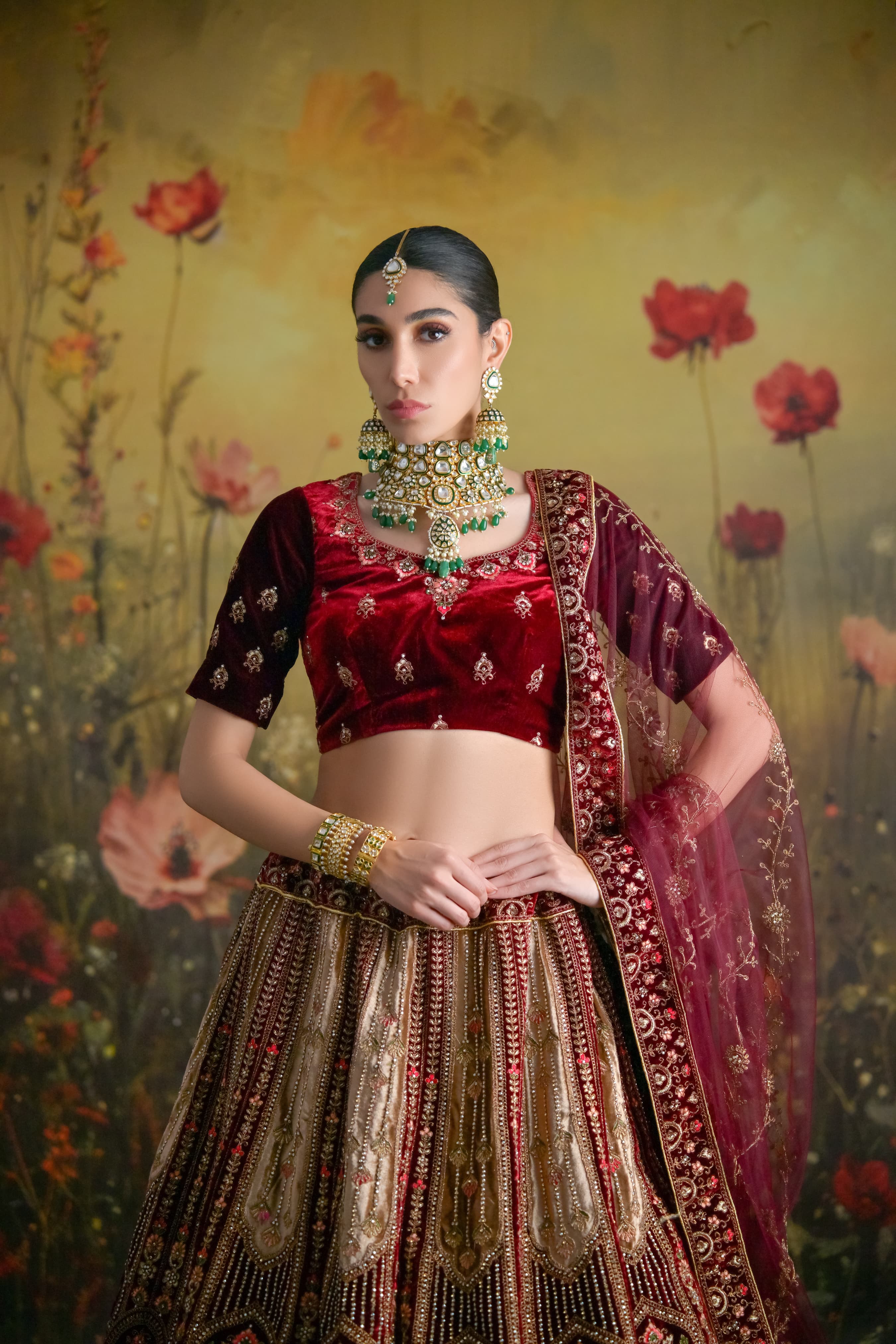 Velvet lehenga choli in wine and gold tones with hand-embroidered zardosi work for brides
