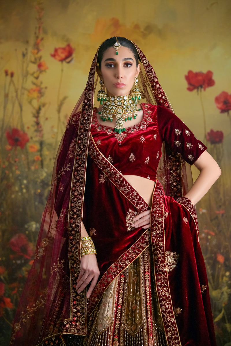 Luxurious wine velvet bridal lehenga featuring antique gold zardosi embroidery