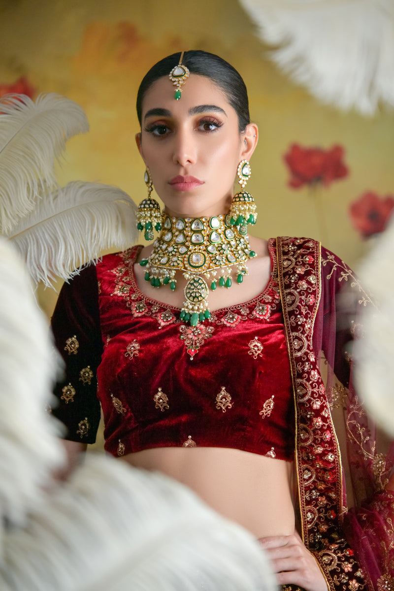 Designer deep wine bridal lehenga crafted in plush velvet with golden zardosi embroidery
