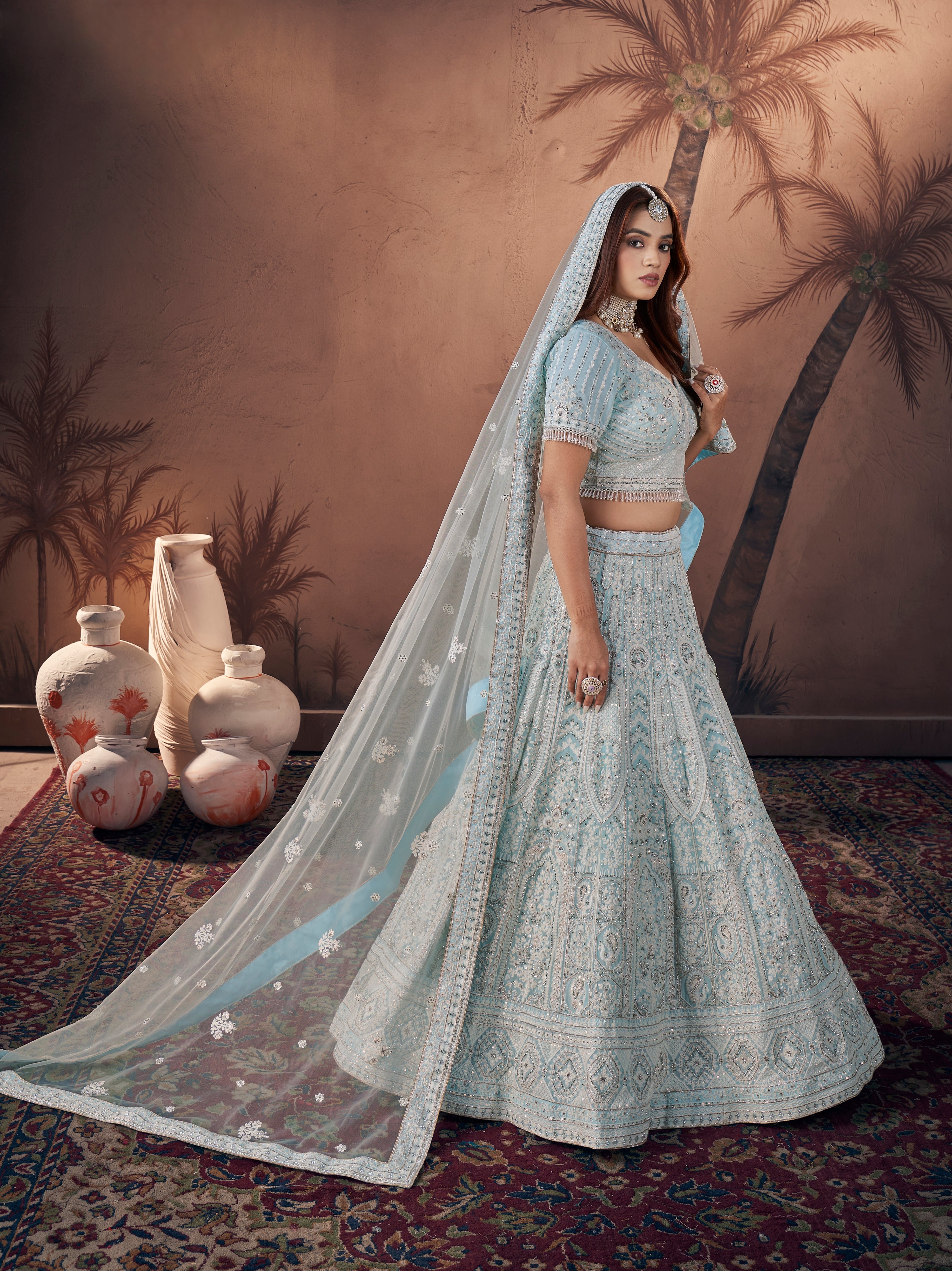 Semi-stitched ice blue bridal lehenga with double can-can and latkans