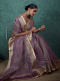 Mauve linen saree draped on model with floral earrings