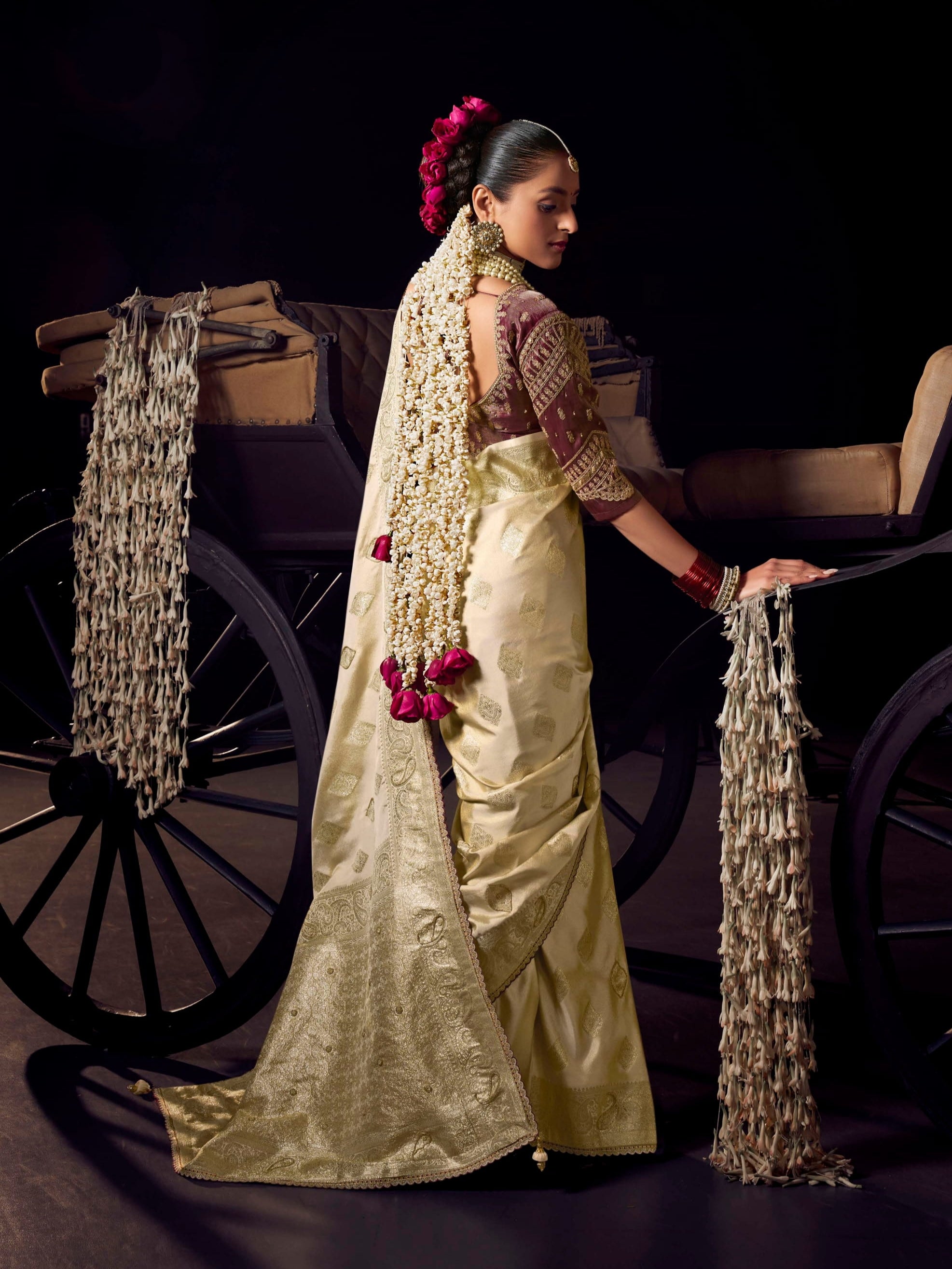 Traditional cream Banarasi silk saree with golden zari and handwork pallu for brides