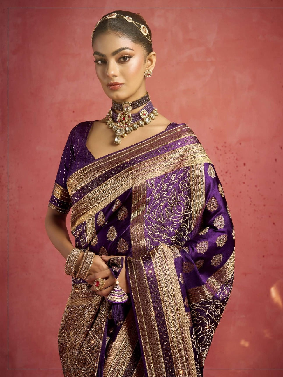 Model wearing purple bridal saree with intricate work