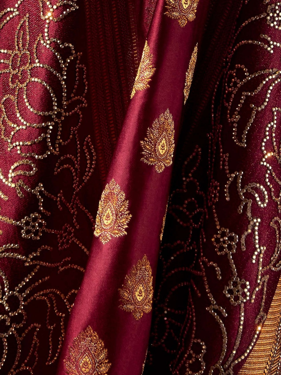 Designer maroon wedding saree with shimmering details

