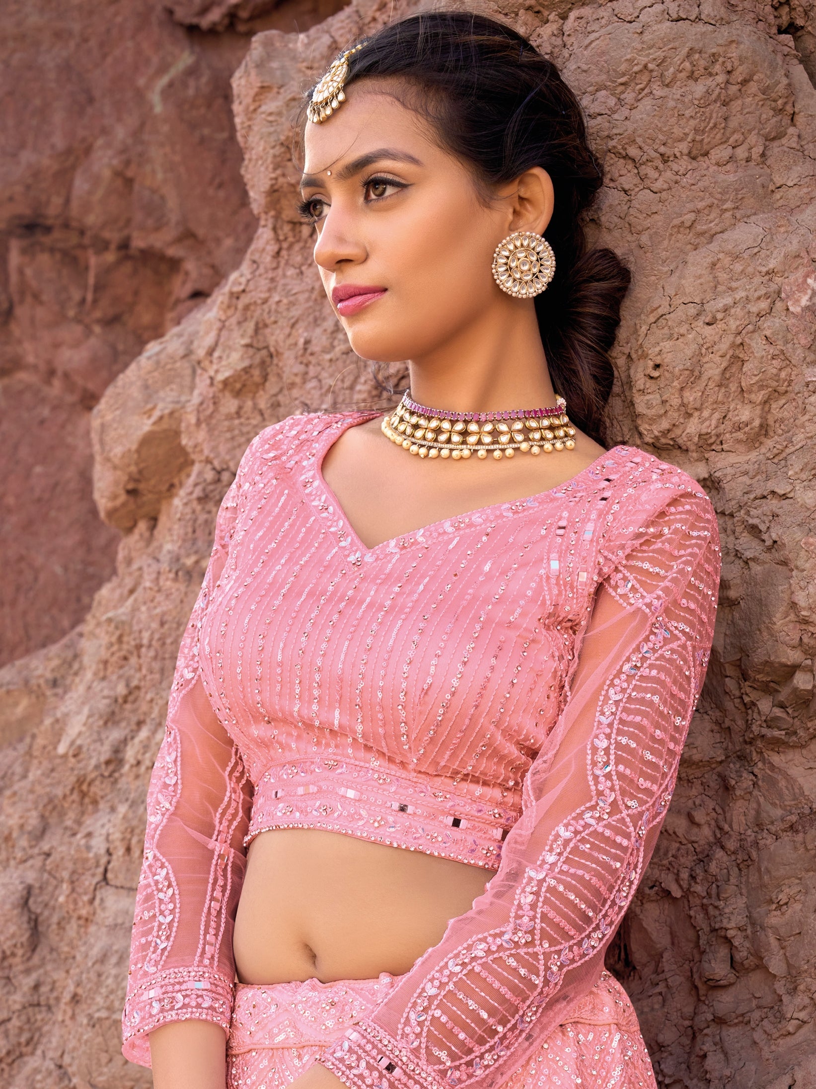 Net lehenga choli in pink with cutwork and heavy detailing