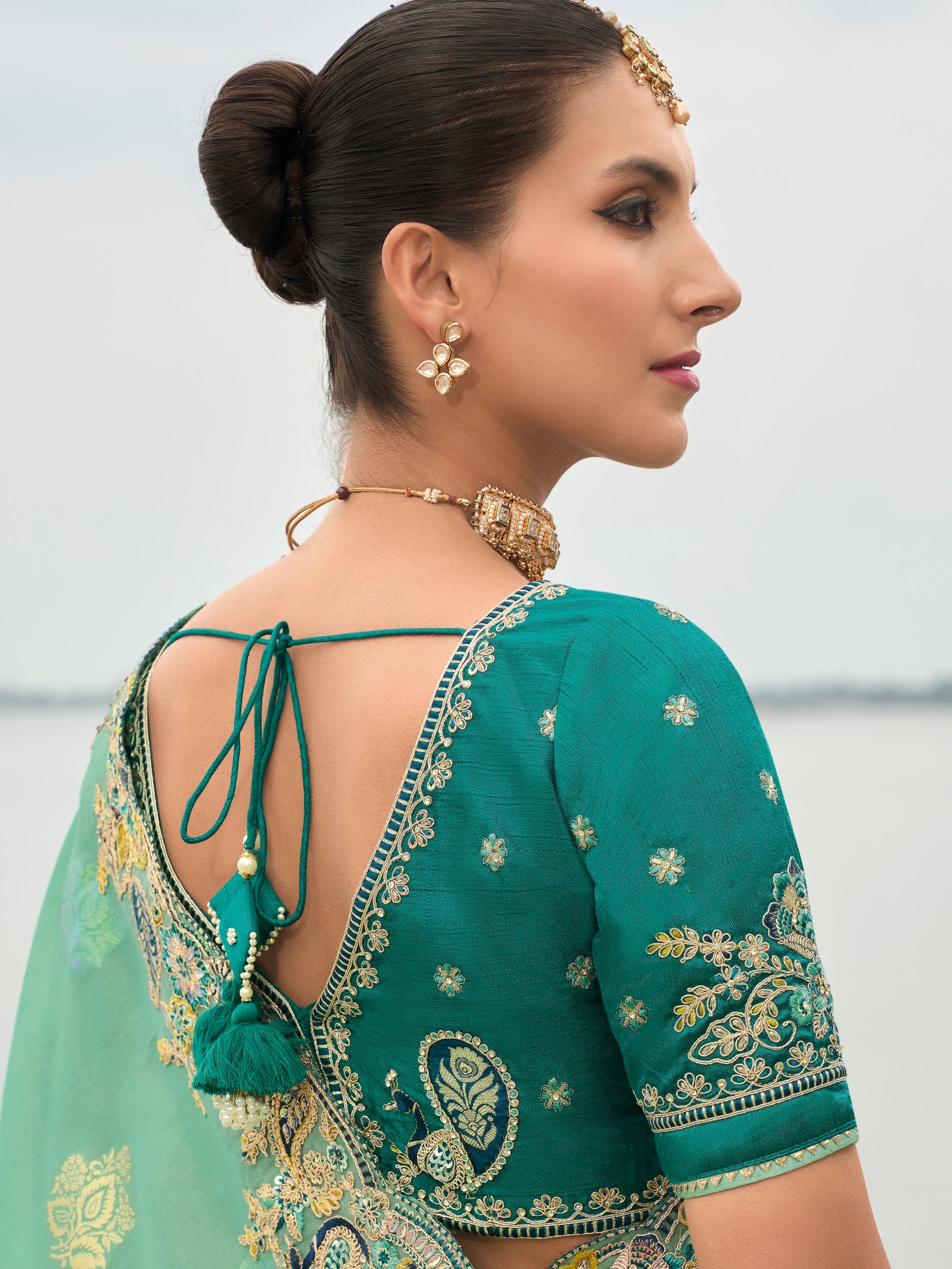 Embroidered butti saree with raw silk blouse for festive events