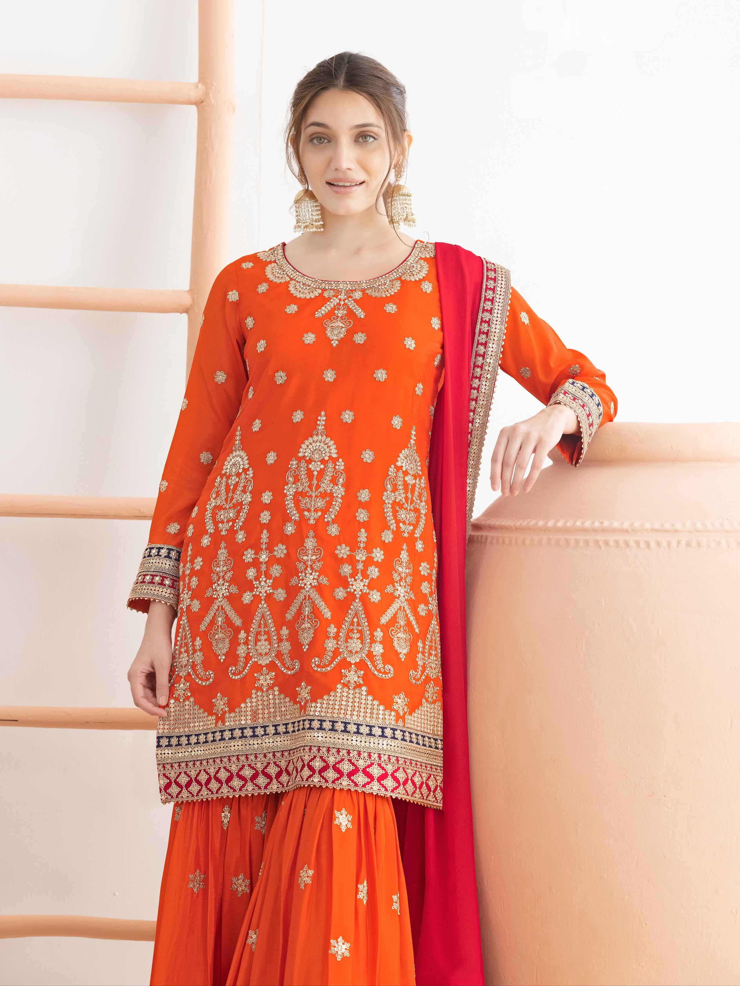 Orange Heavy Work Chinnon Sharara Suit with Red Dual Shade Dupatta Sharara Suit Anant Tex Exports Pvt.Ltd..