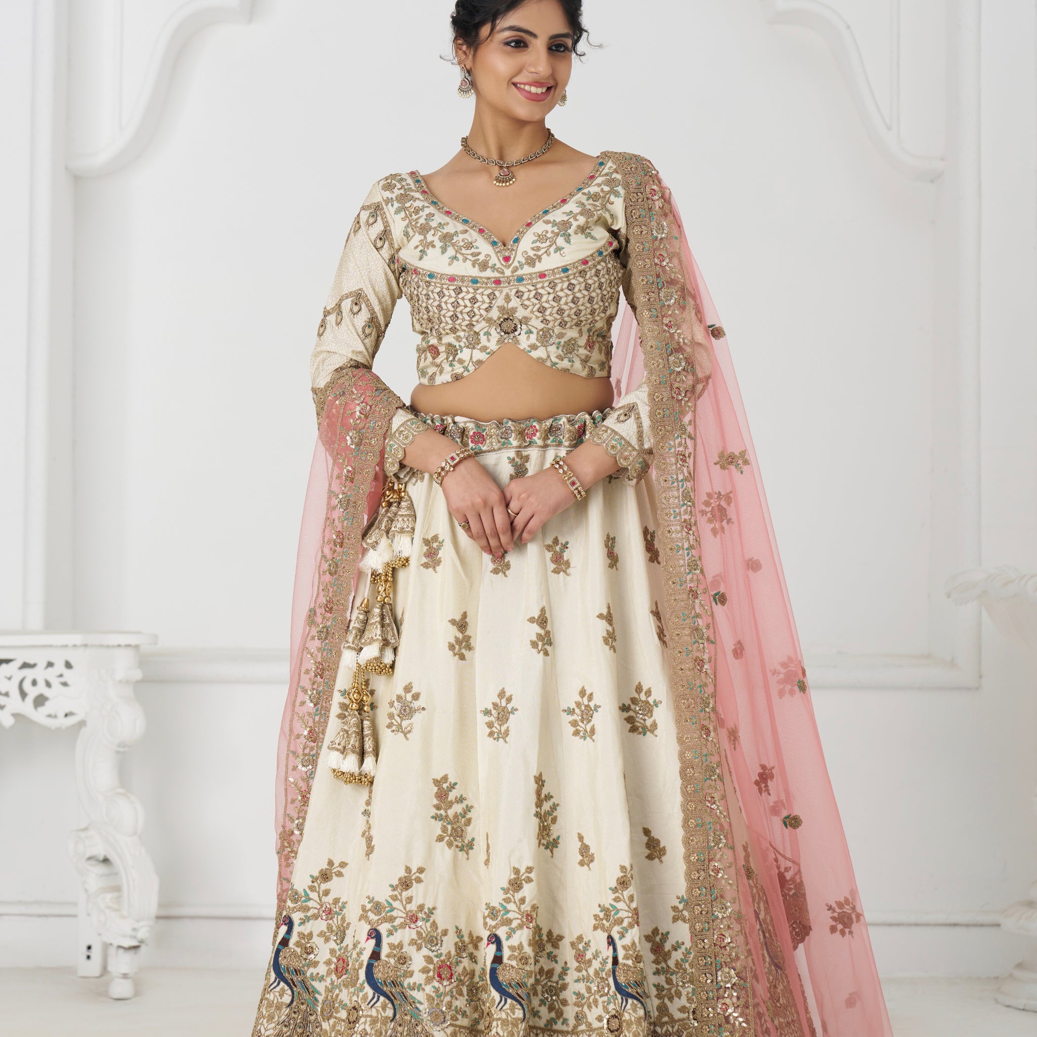 White zari silk bridal lehenga with contrasting pink dupatta and intricate embroidery