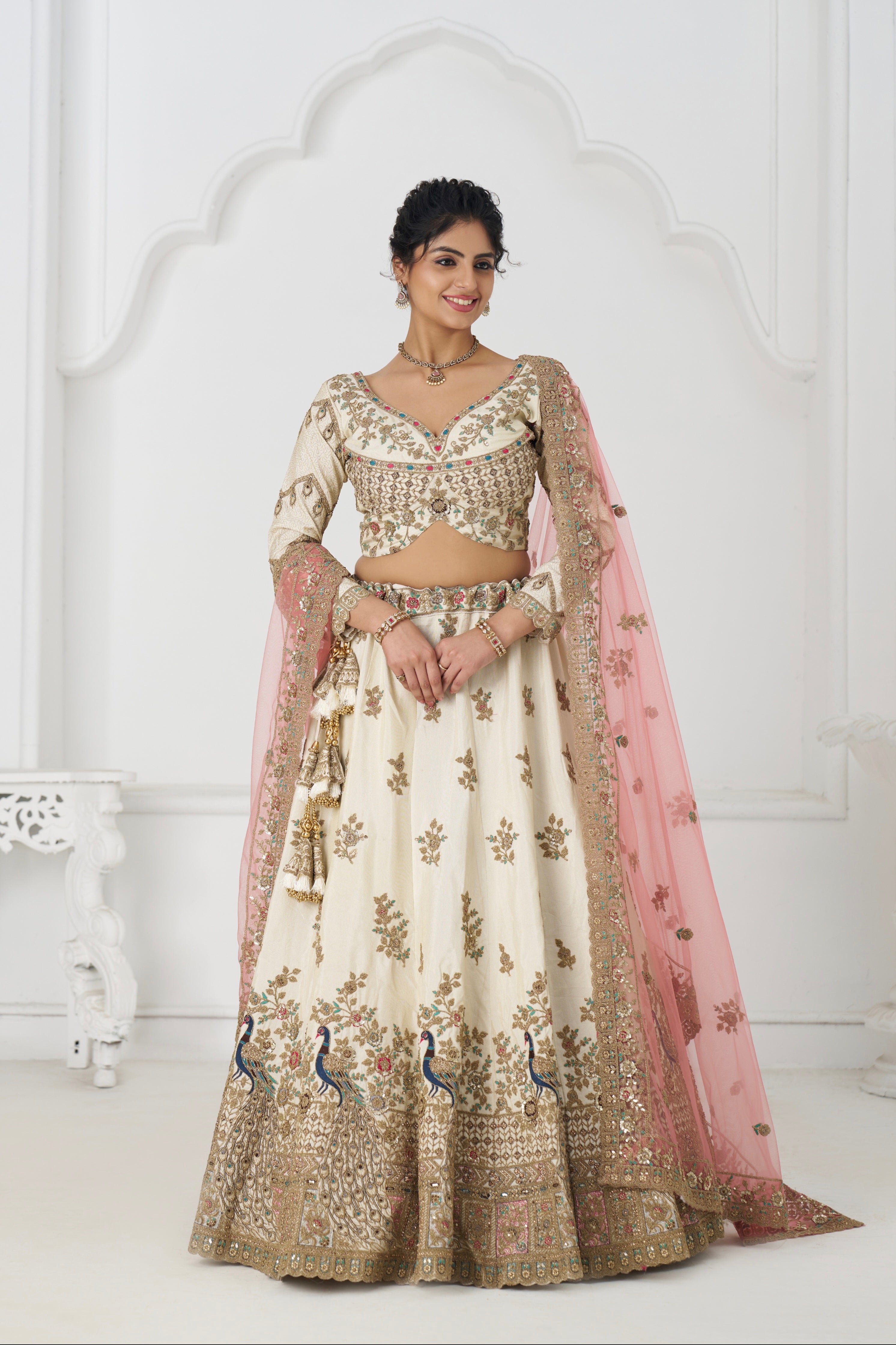 White zari silk bridal lehenga with contrasting pink dupatta and intricate embroidery