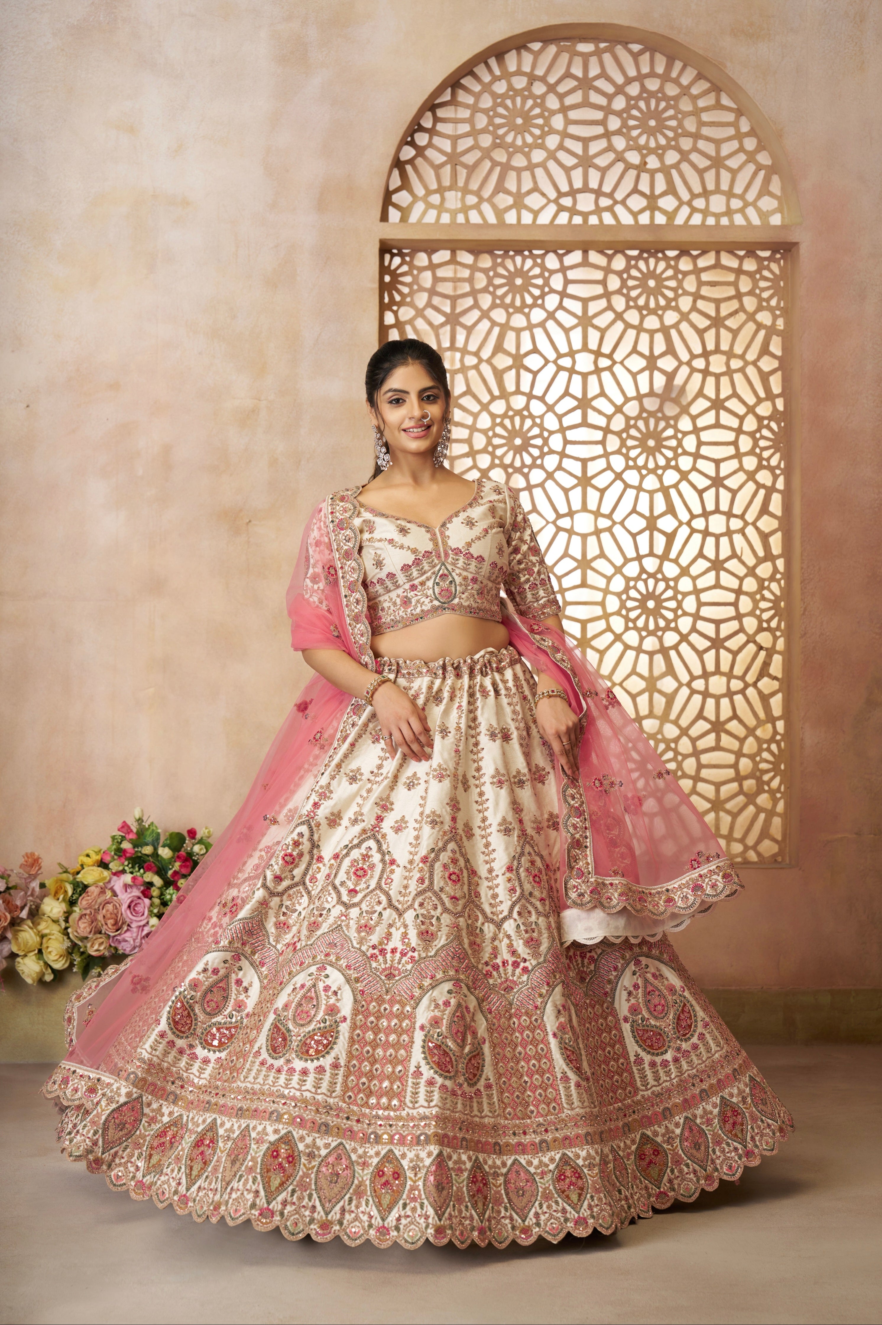 Traditional Indian bridal outfit featuring white lehenga and pink dupatta