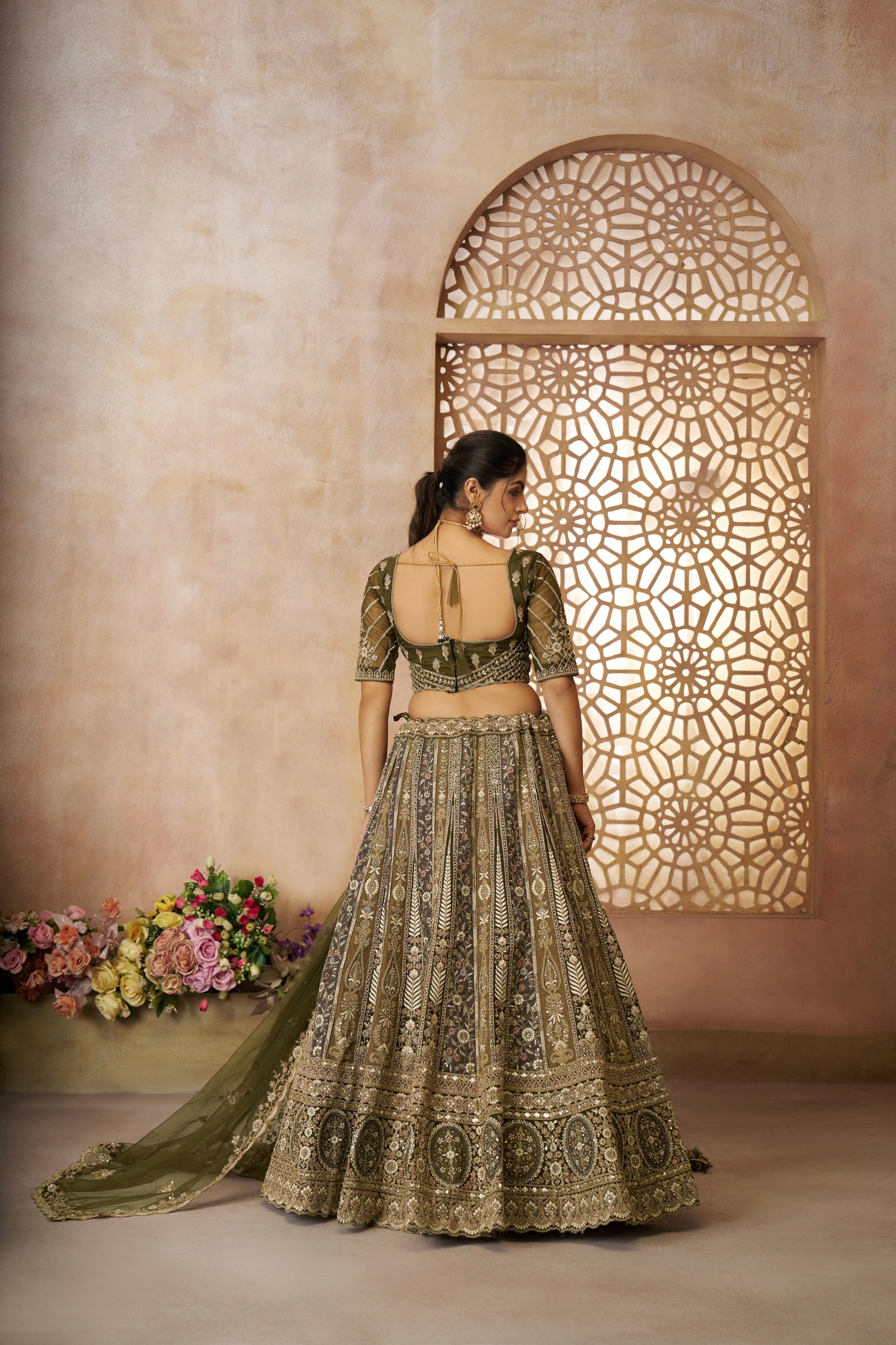 Heavily embellished mehendi green bridal lehenga with matching choli and dupatta
