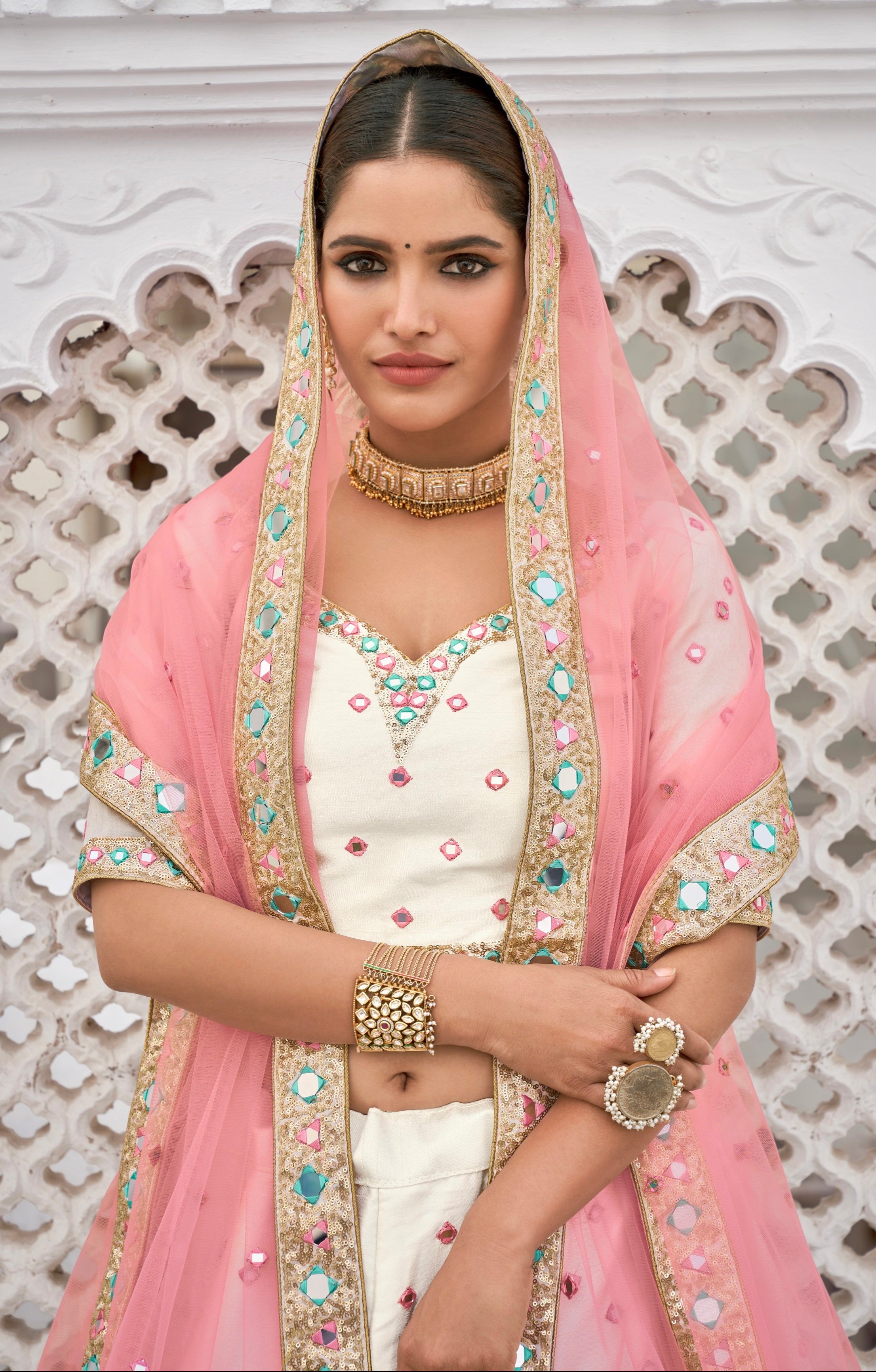 Close-up of mirror work choli and pink net dupatta

