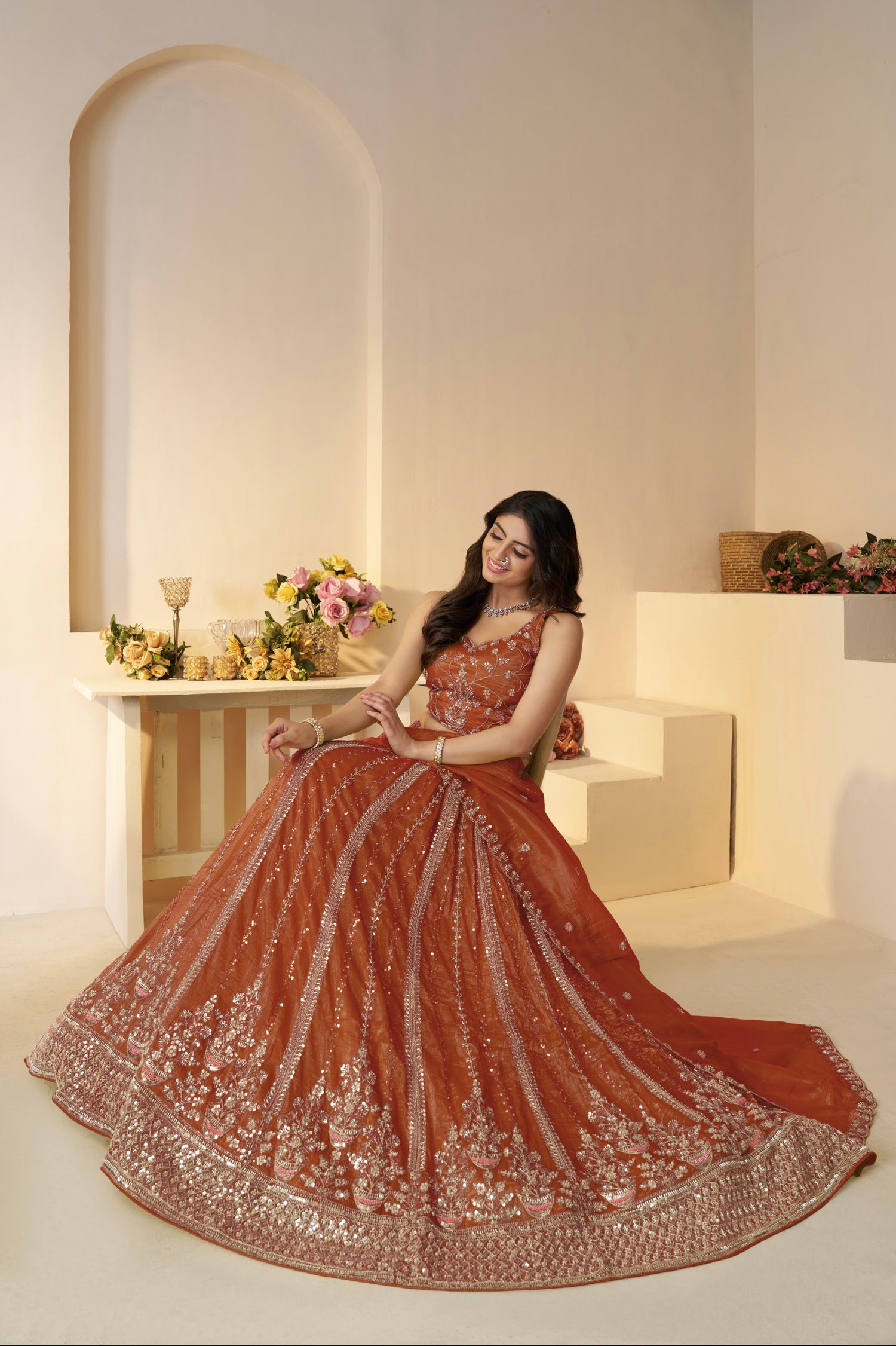 Front view of orange designer lehenga with sequin and zari

