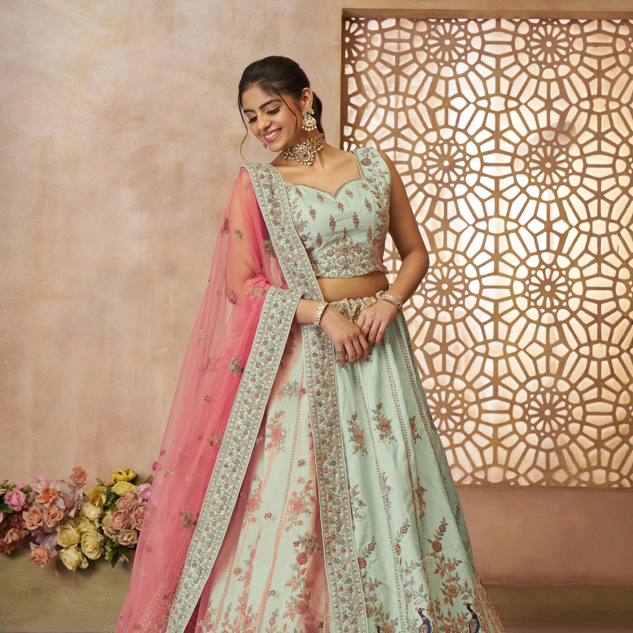 Green zari silk bridal lehenga with intricate peacock embroidery and traditional detailing