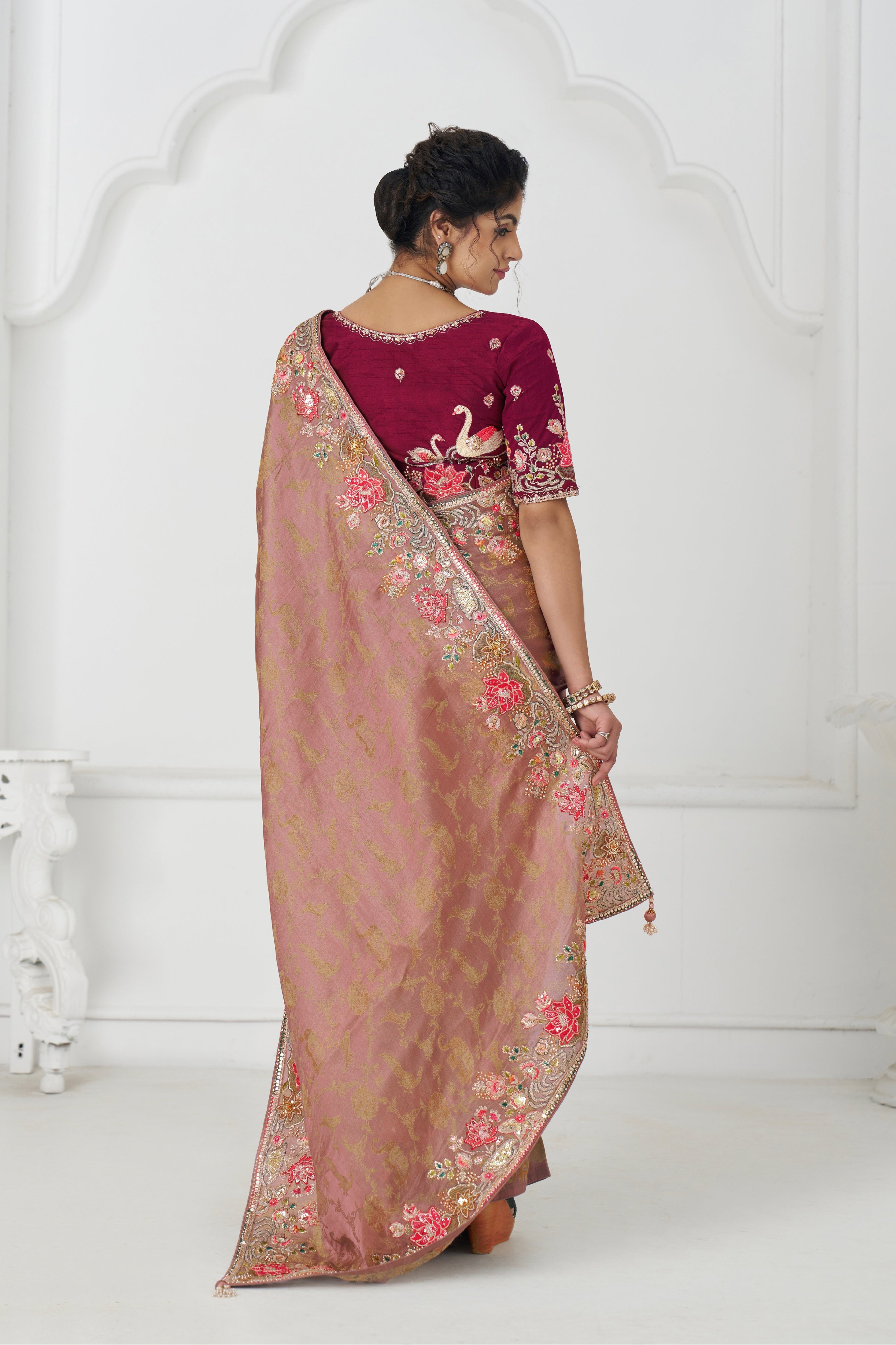 Festive peach saree with traditional thread and beadwork