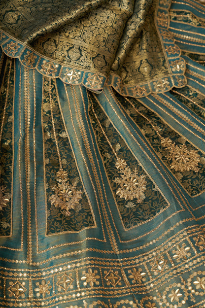 Close-up of zari work on green bridal lehenga

