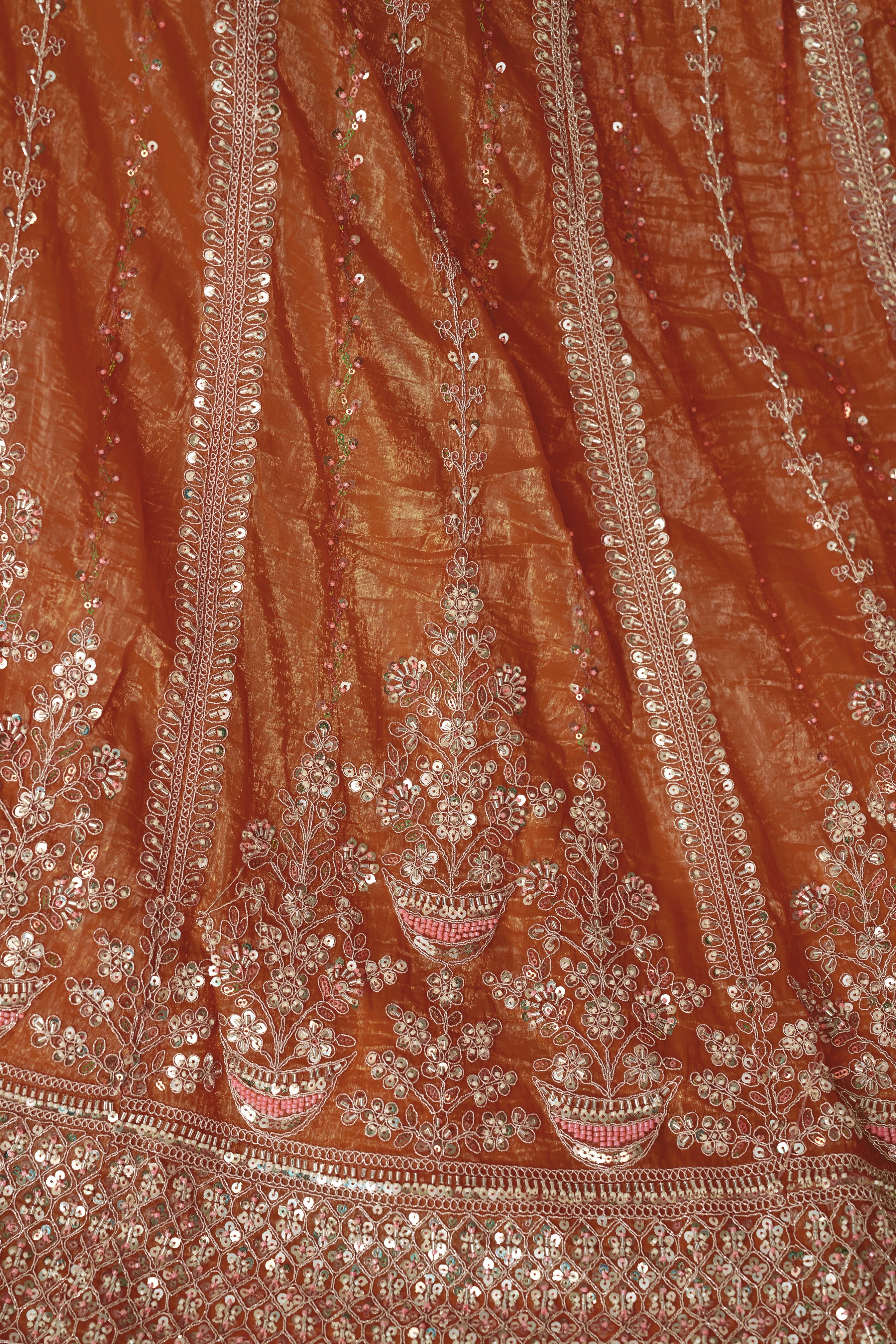 Orange lehenga skirt with intricate zari detailing

