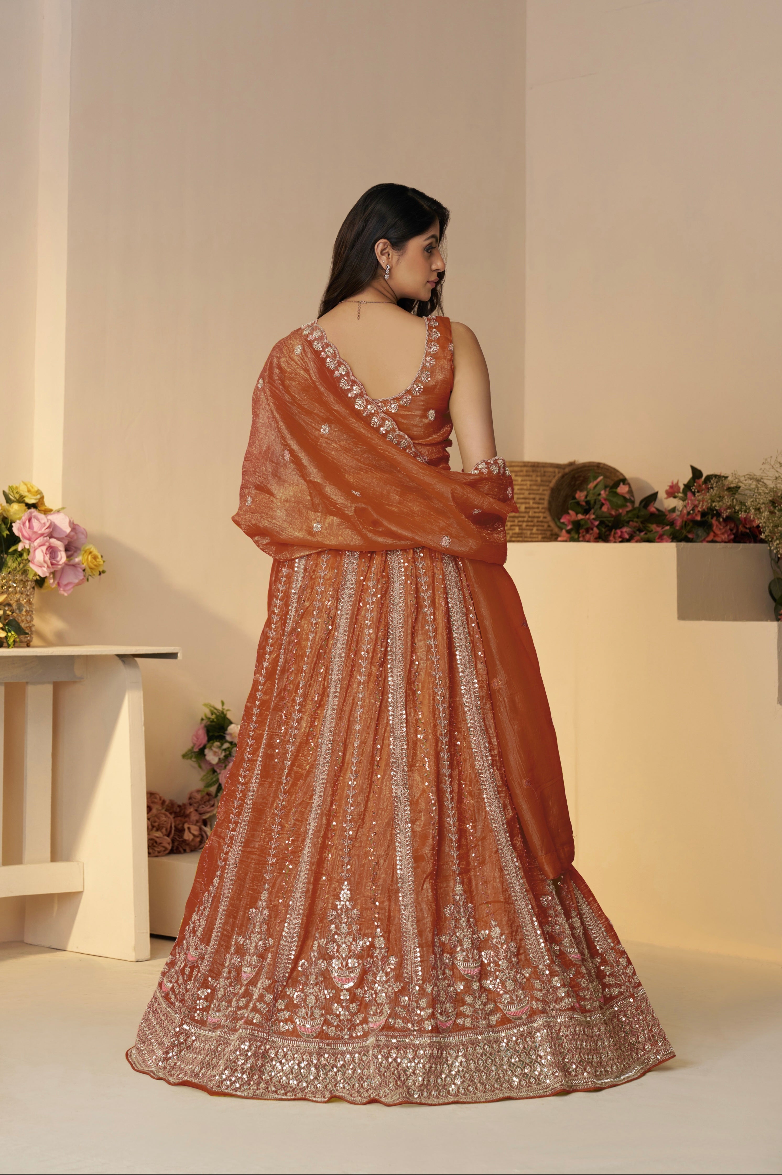 Back view of orange bridal lehenga with dupatta drape

