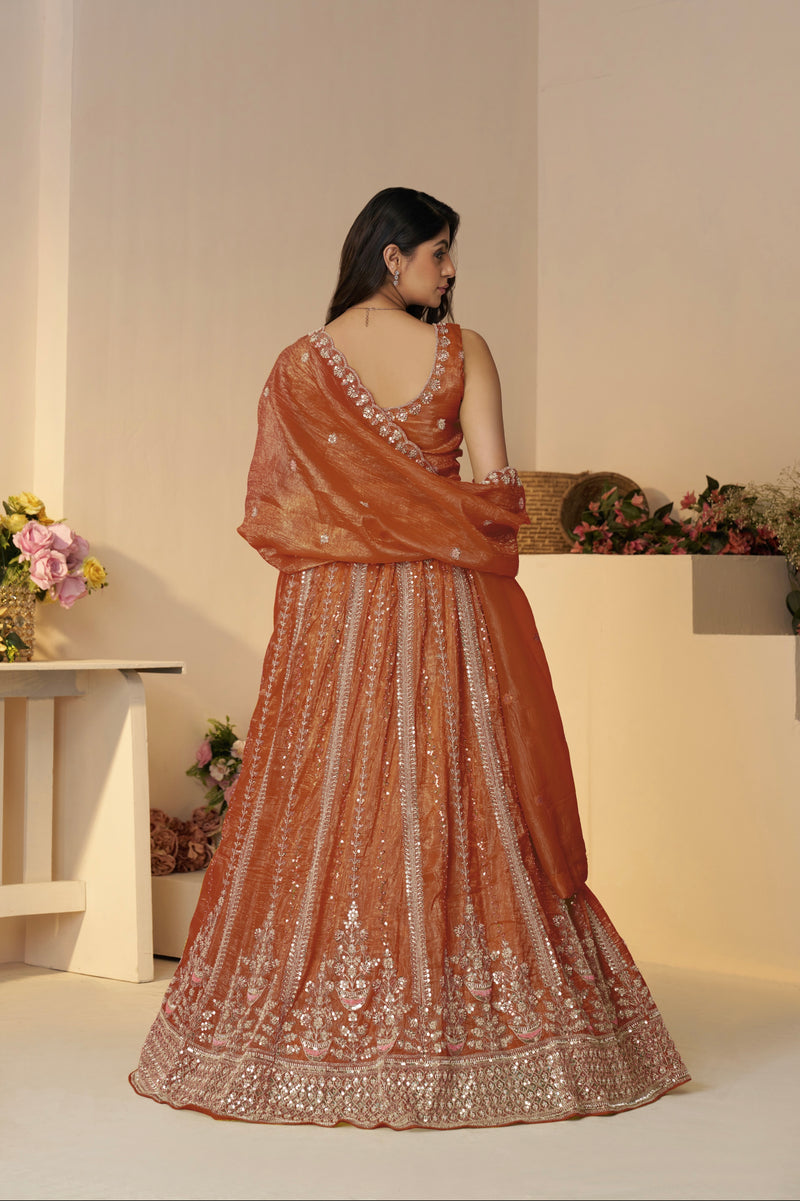 Back view of orange bridal lehenga with dupatta drape

