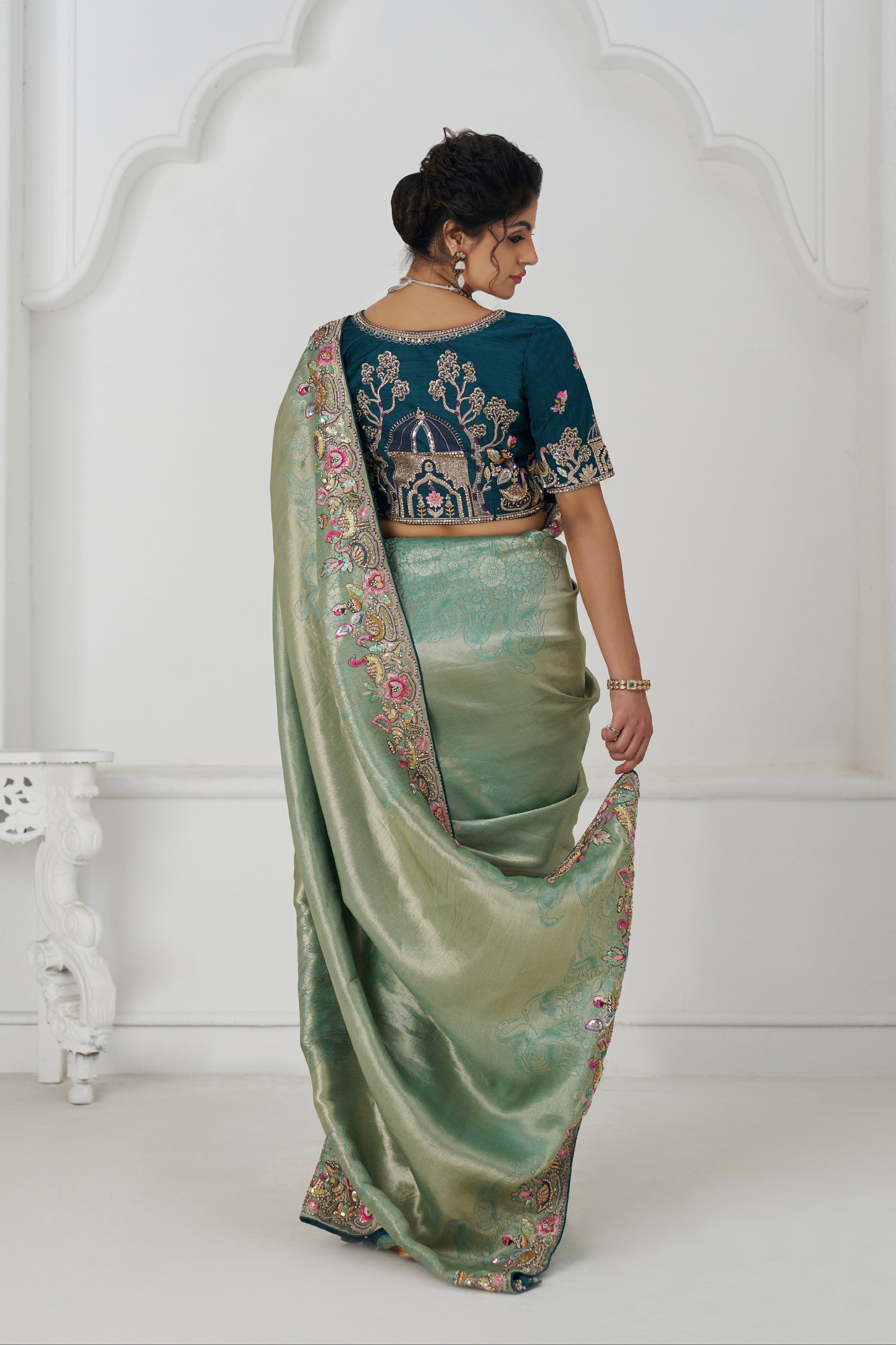 Elegant green party wear saree with embroidered detailing