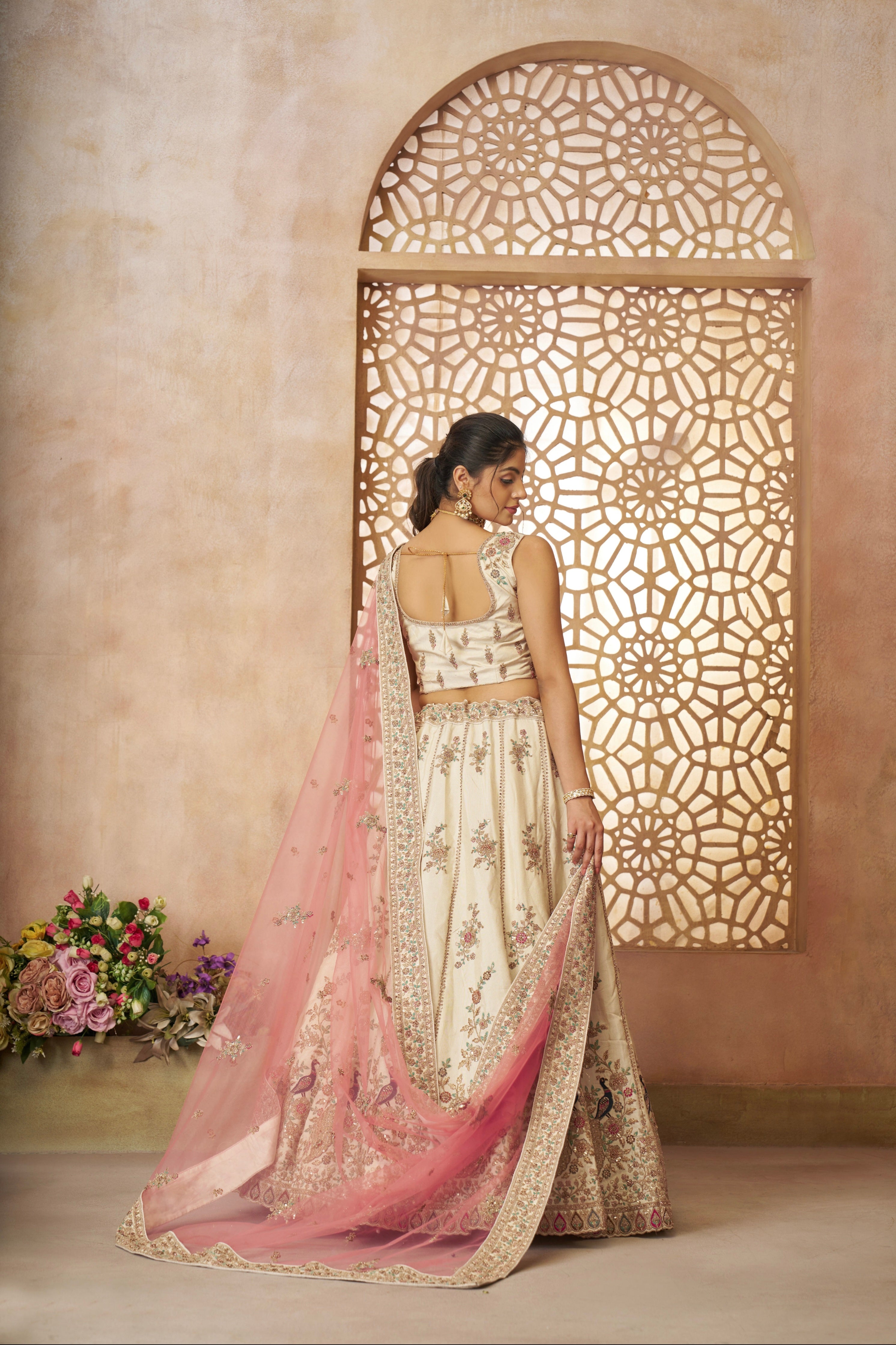White zari bridal lehenga with pink dupatta and intricate handcrafted details