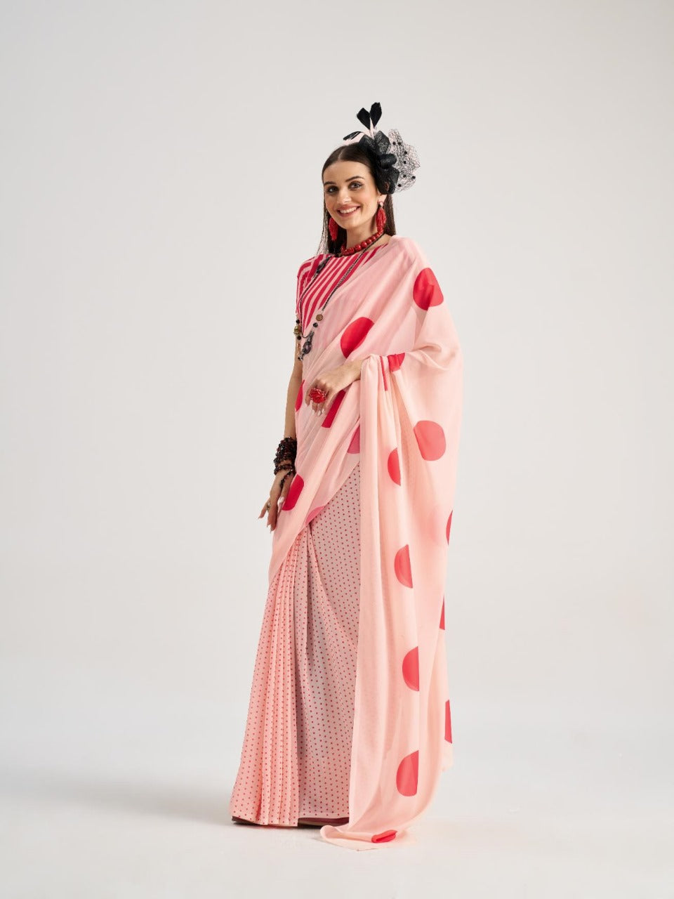 Light pink georgette saree with red polka dot print


