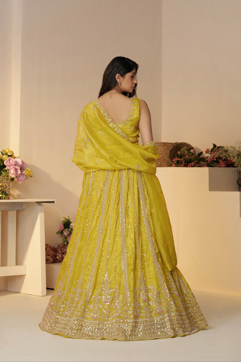 Stone-studded lehenga in yellow with Jimmy Choo design flair