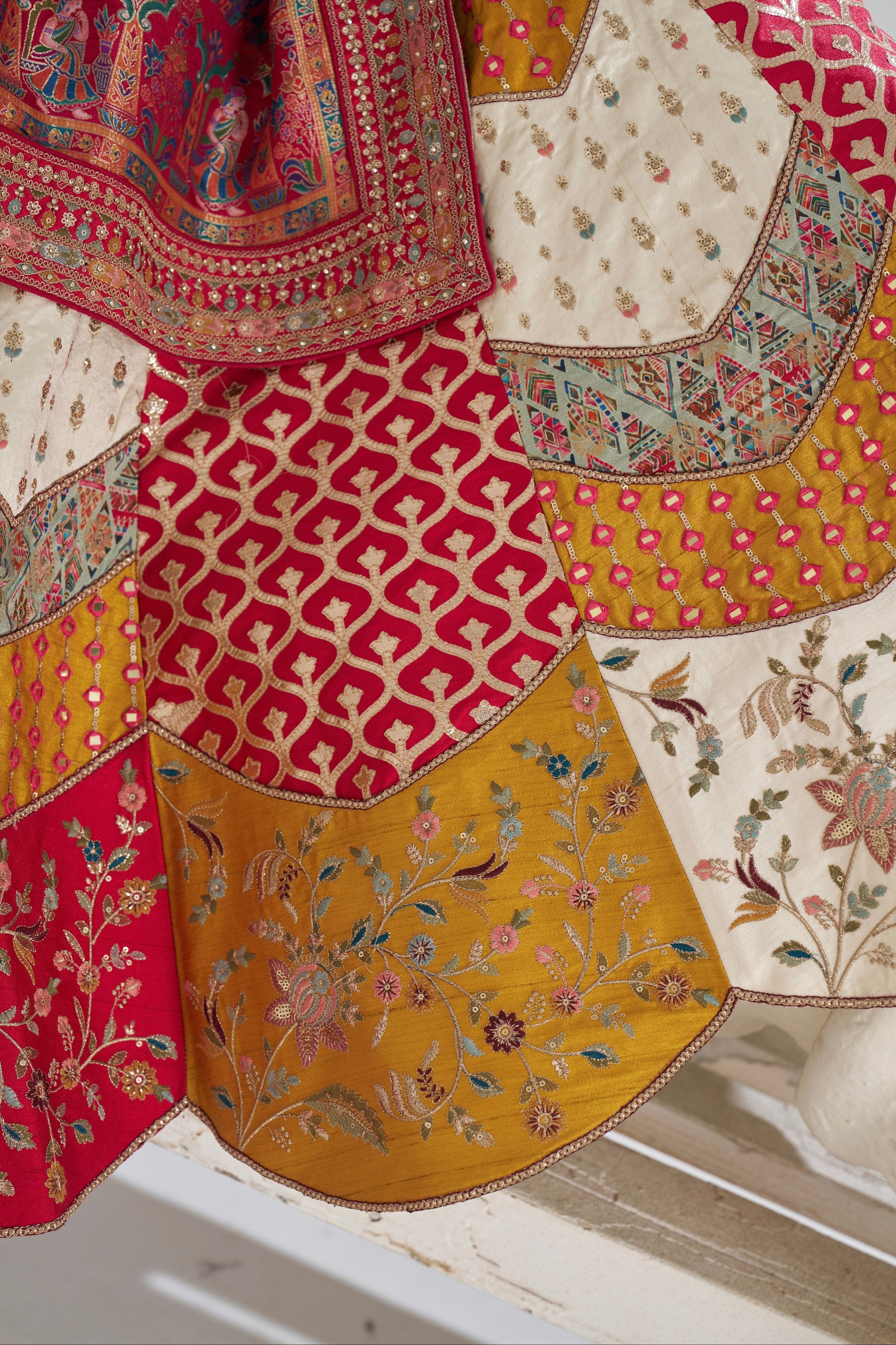 Close-up of zari weaving on white bridal lehenga