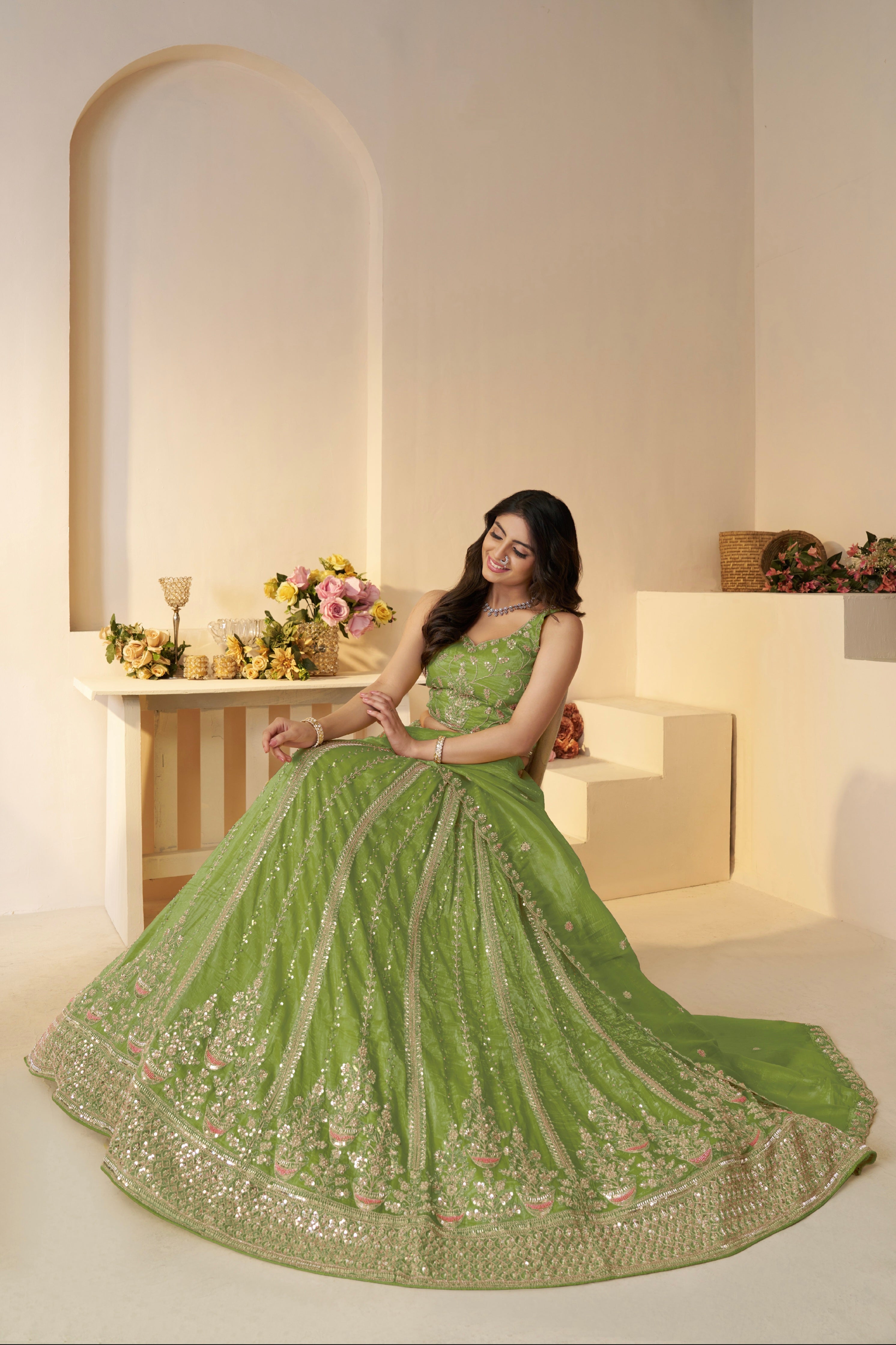 Front view of heavily embellished green bridal lehenga

