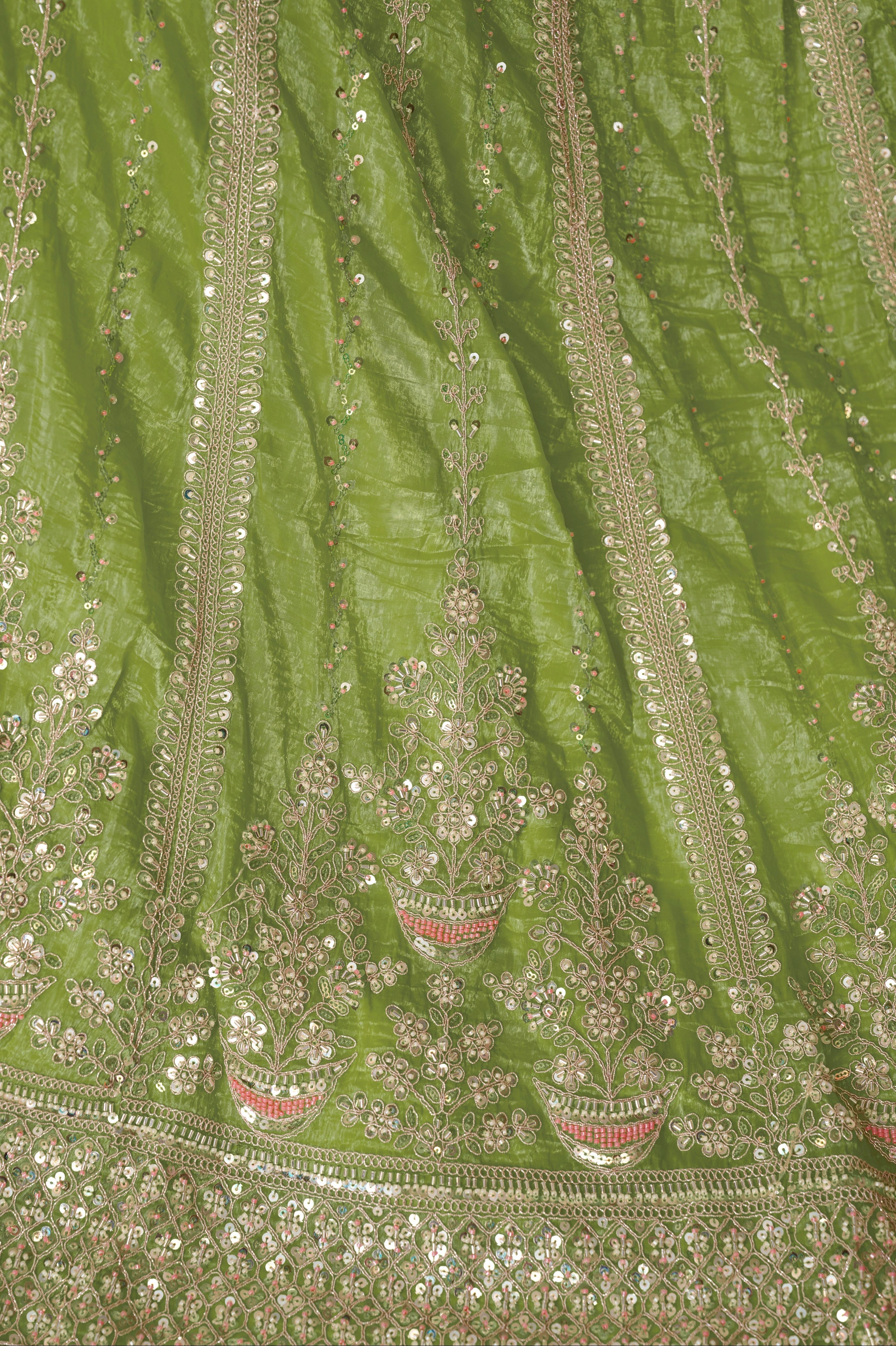 Close-up of embroidery on green lehenga skirt and blouse

