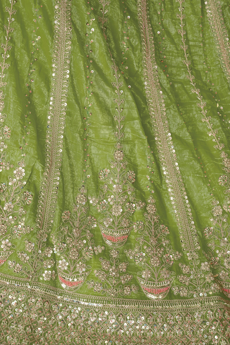 Close-up of embroidery on green lehenga skirt and blouse


